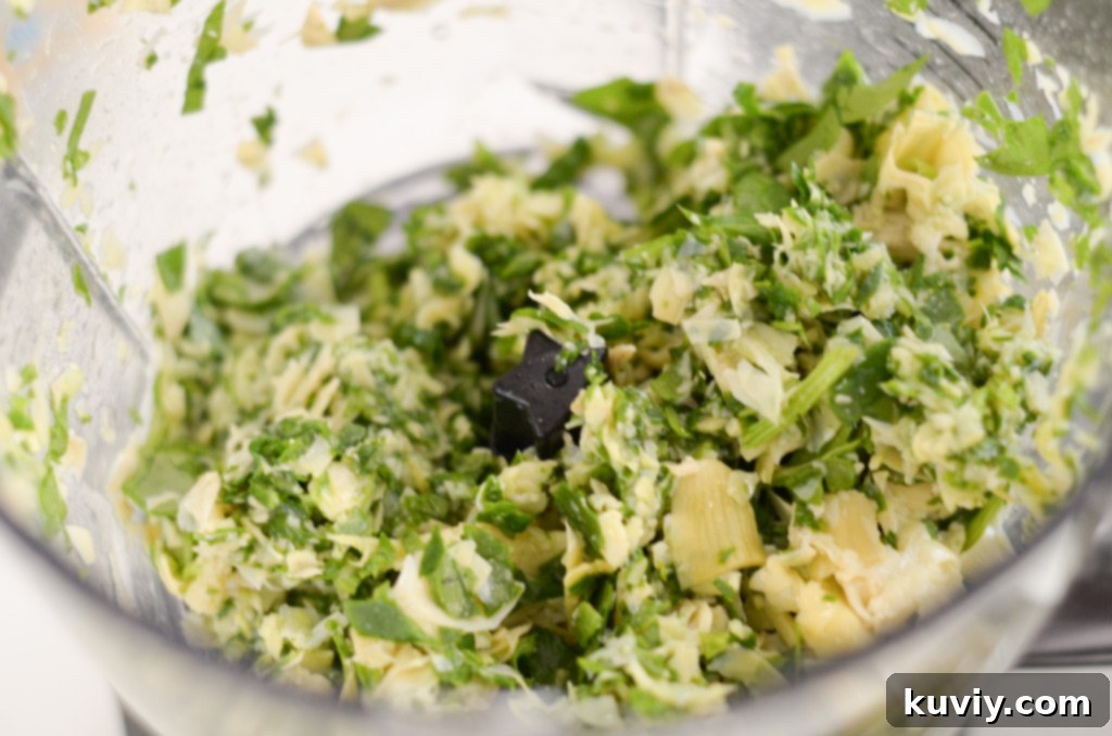 Fresh spinach and canned artichoke hearts, essential ingredients laid out for preparing a delicious air fryer spinach dip.