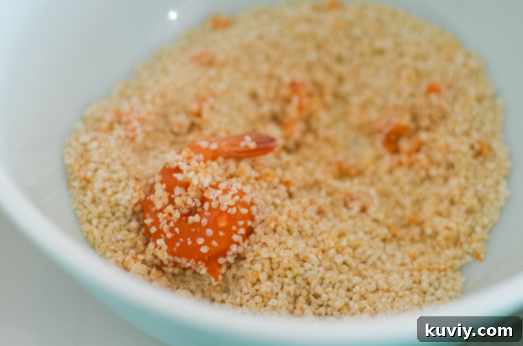 Close-up of frozen, cooked, tail-on shrimp, ideal for air frying