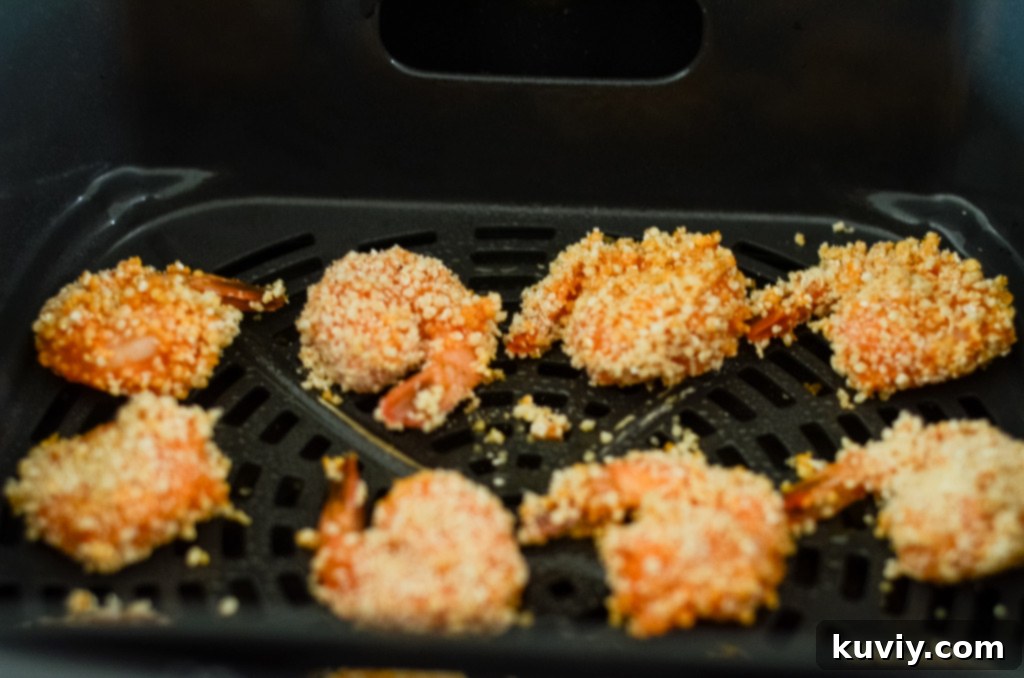 Coating shrimp in buffalo sauce and breadcrumbs for air frying