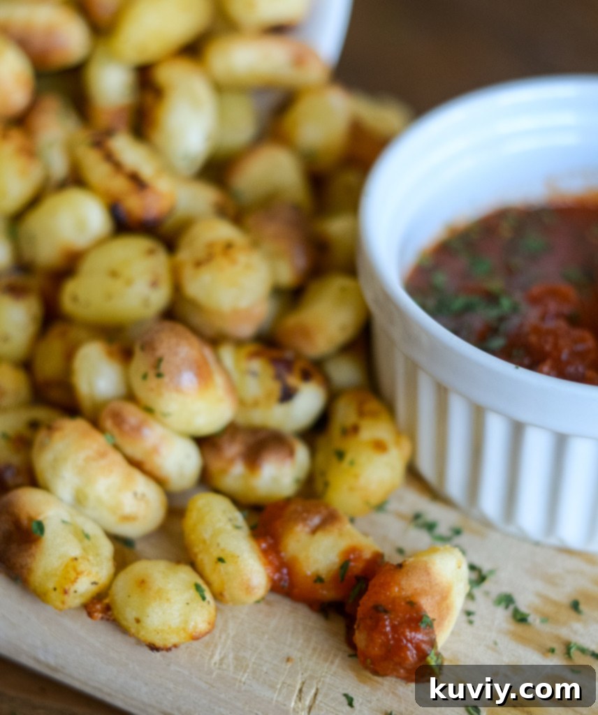 Air fryer frozen gnocchi served with marinara sauce and fresh herbs