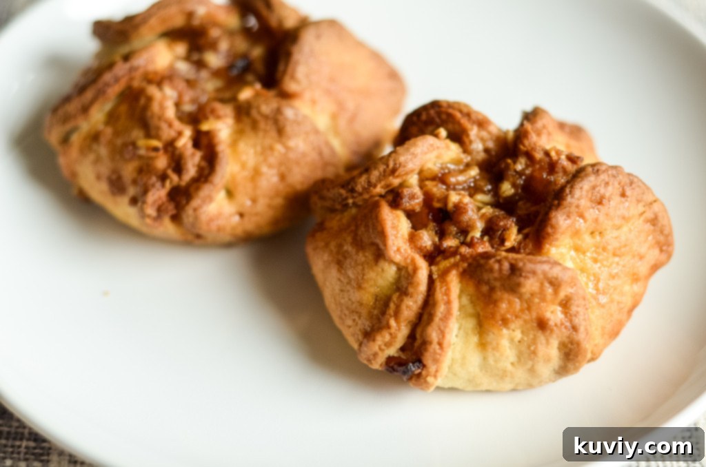 Apple blossoms cooking inside an air fryer basket, showing a golden brown crust
