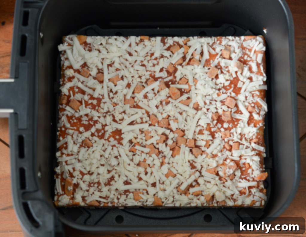 Air fryer basket with a perfectly cooked Totino's Pizza