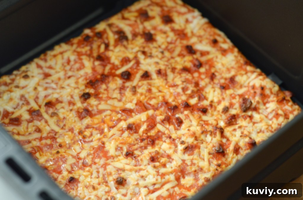 Unwrapped Totino's Pizza placed directly into the air fryer basket
