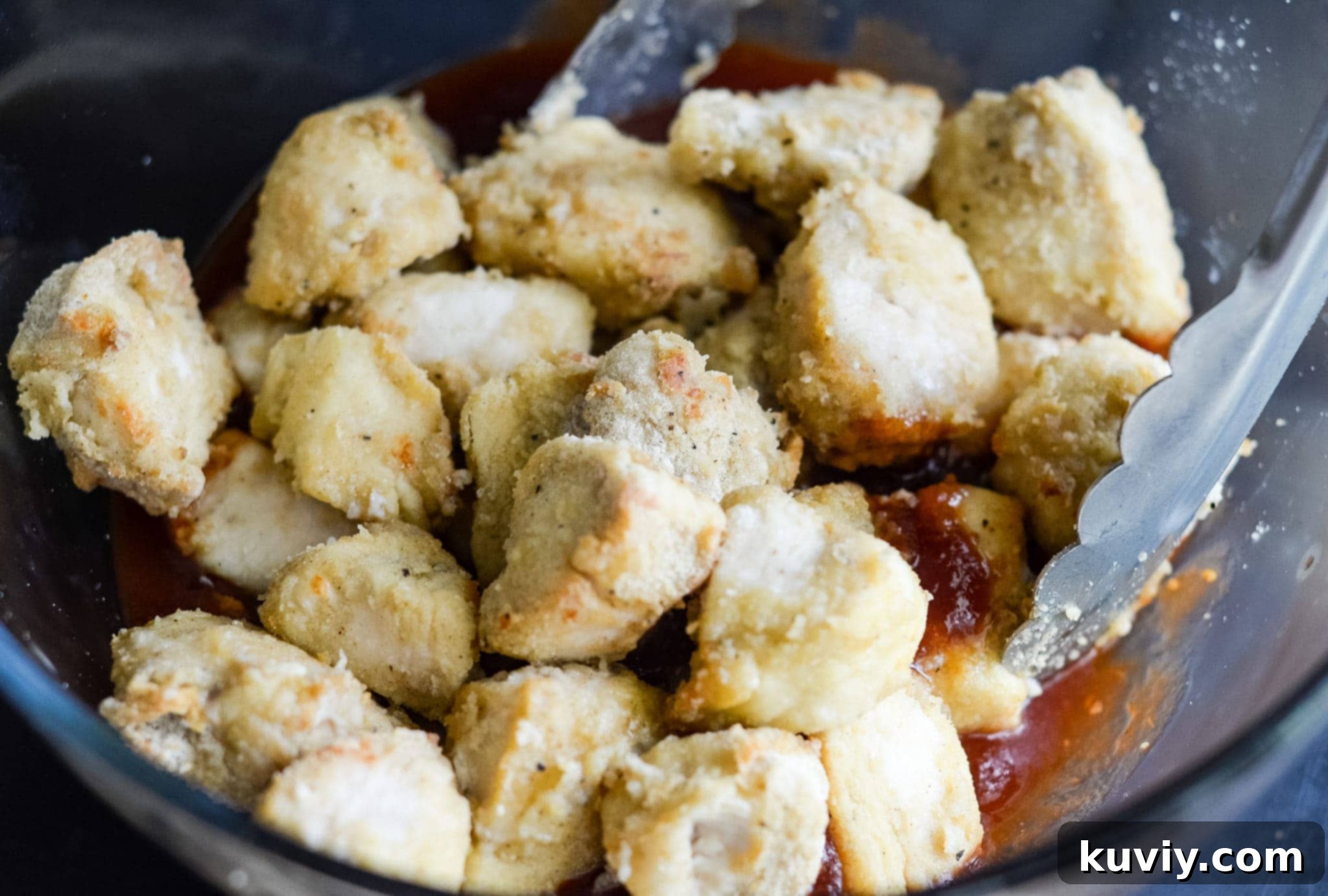 Chicken pieces coated in seasoned flour, ready for the air fryer.