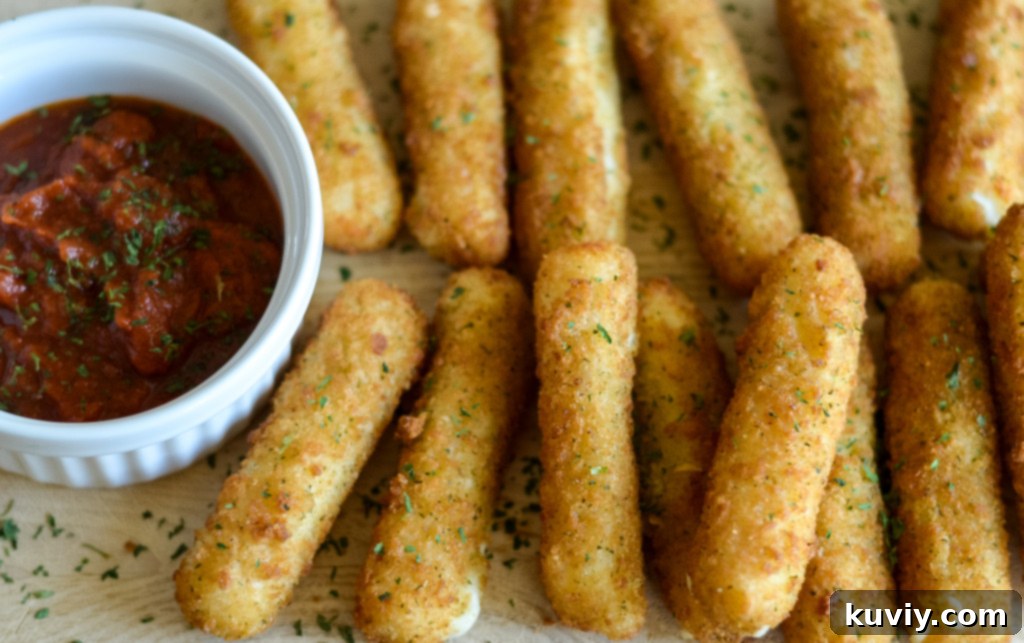 Air Fryer Frozen Mozzarella Sticks cooking in the basket