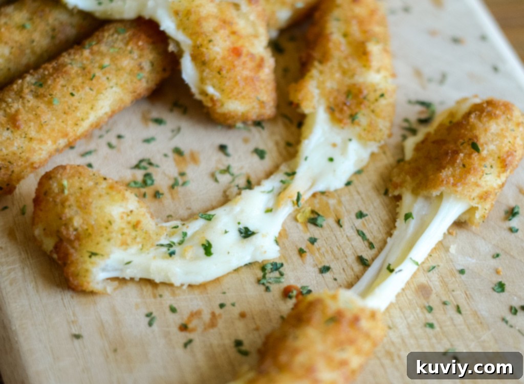 Air Fryer Frozen Mozzarella Sticks with dipping sauce on a plate