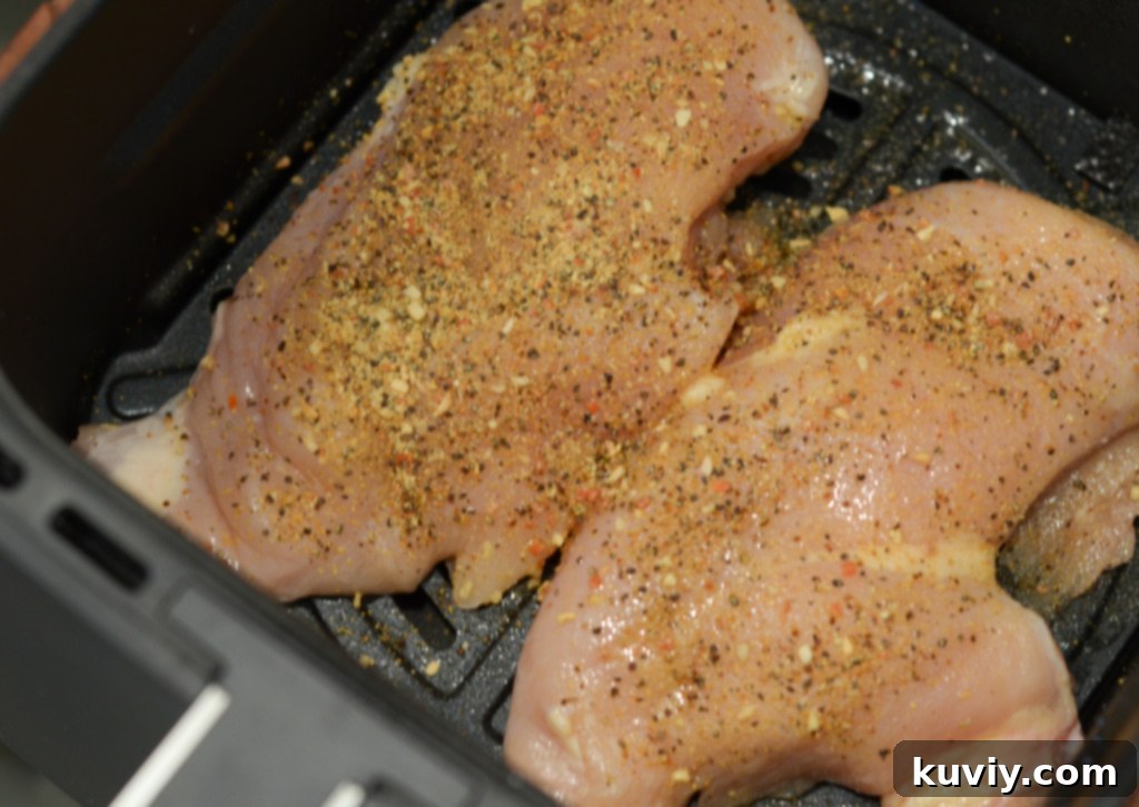 uncooked chicken breast in the air fryer with lemon pepper