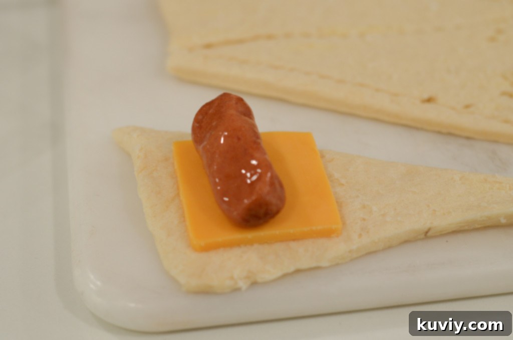 preparing pigs in a blanket with cheese