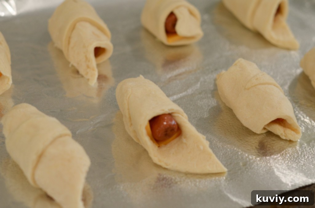 this image shows air fryer pigs in a blanket about to go into the air fryer.