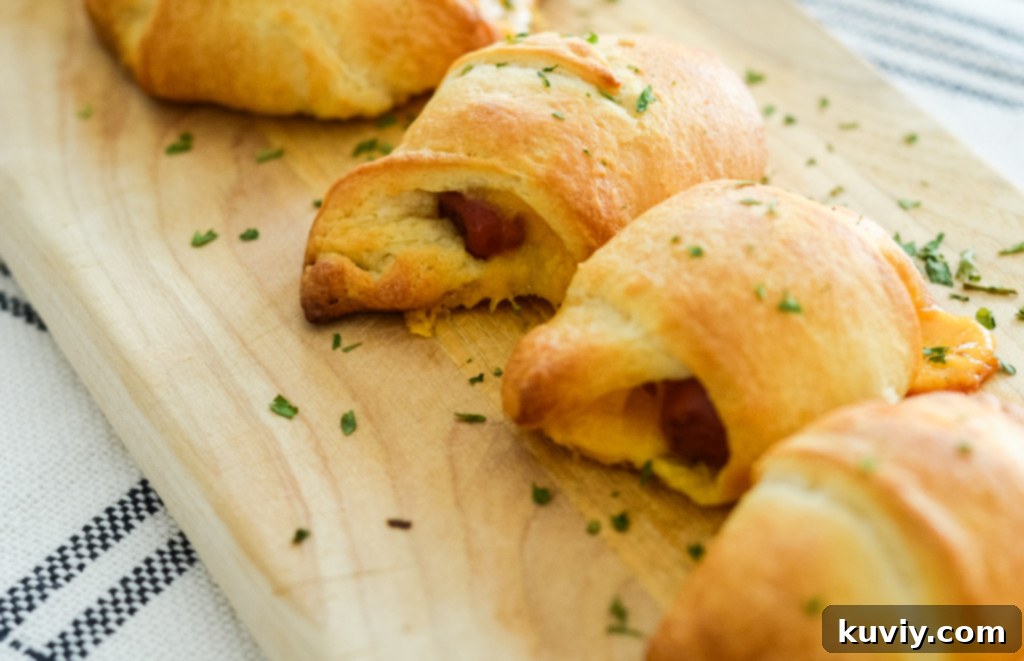 This image shows prepared pigs in a blanket with cheese made in the air fryer.