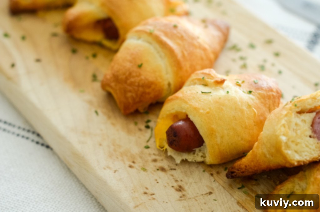 This image shows cocktail sausage inside a crescent roll.
