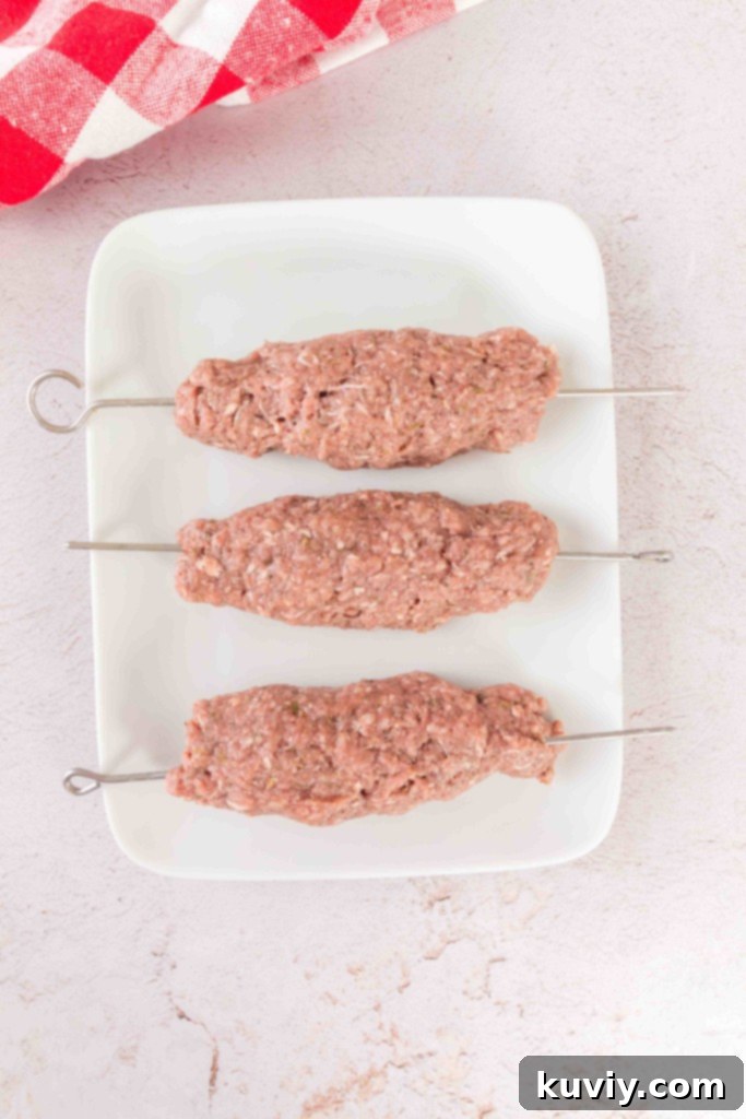 Air Fryer Ground Beef Kebabs on skewers, uncooked and shaped