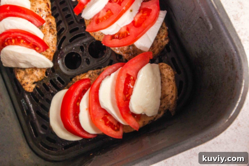 Marinating chicken breasts with fresh herbs and spices for Air Fryer Caprese Chicken