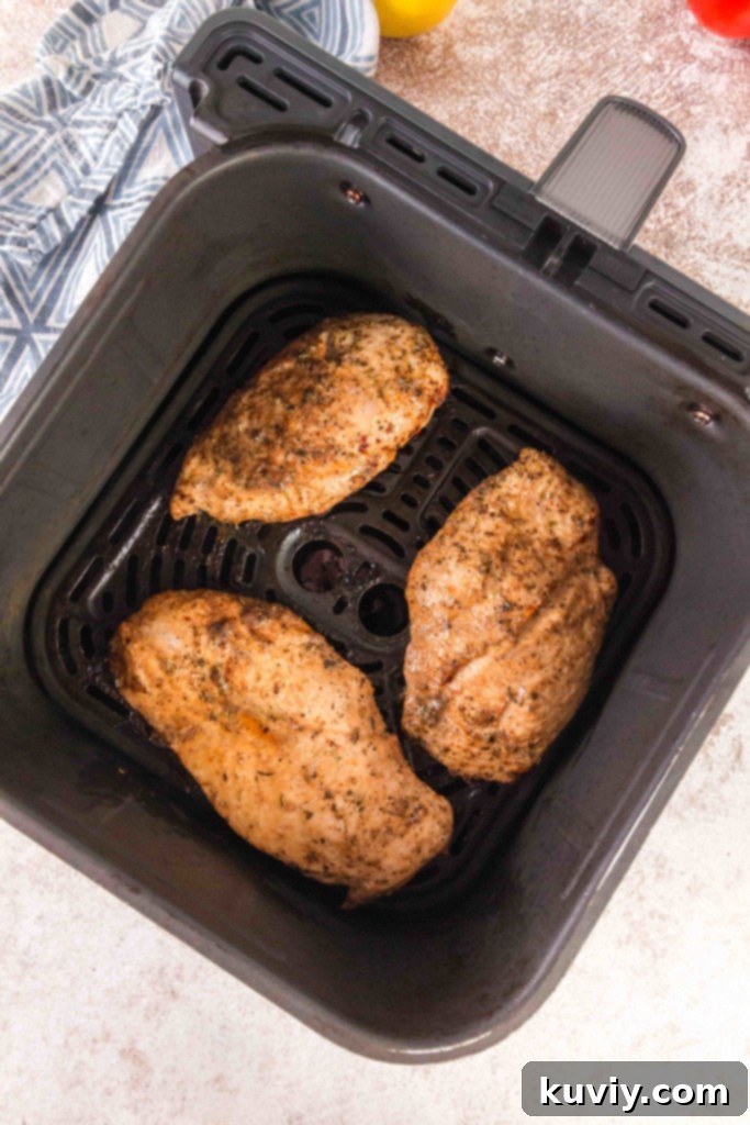 Perfectly cooked Air Fryer Caprese Chicken with melted mozzarella and basil