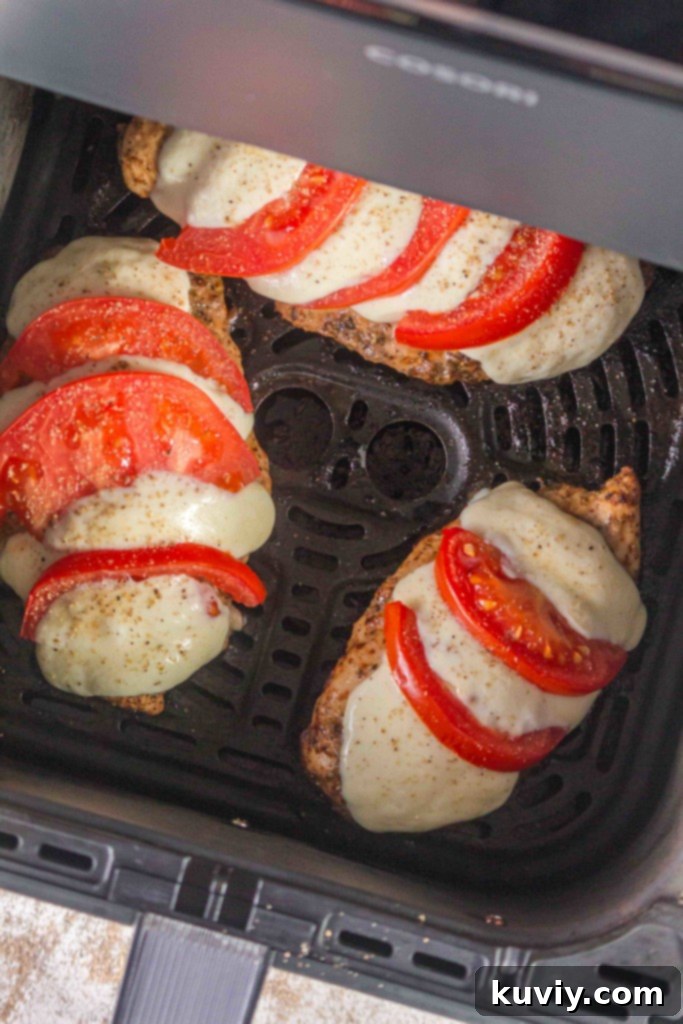 Close-up of air fried chicken with melted Caprese toppings