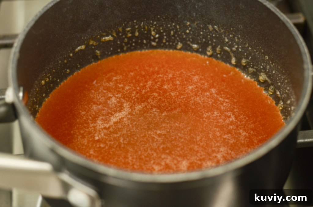 Crispy Hot Honey Air Fryer Chicken Bowls 3 A selection of ingredients for the hot honey sauce, including a bottle of honey, sriracha, and brown sugar, neatly arranged.