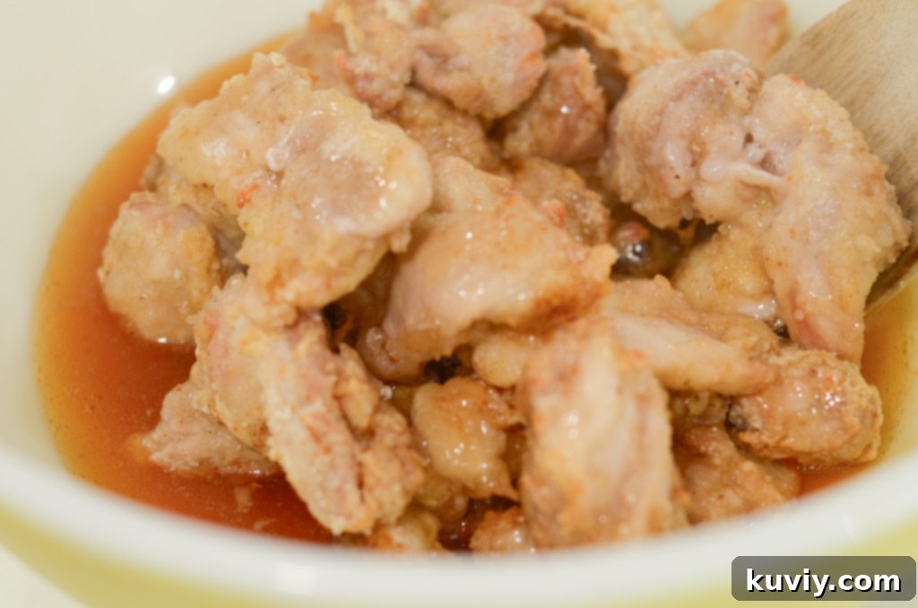 Crispy Hot Honey Air Fryer Chicken Bowls 5 Four colorful hot honey chicken bowls with various toppings like green onions and sesame seeds, illustrating different serving styles.