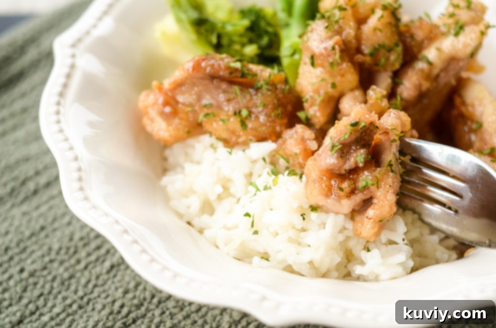 Crispy Hot Honey Air Fryer Chicken Bowls 7 Meal prep containers filled with hot honey chicken, rice, and broccoli, ready for storage or transport.