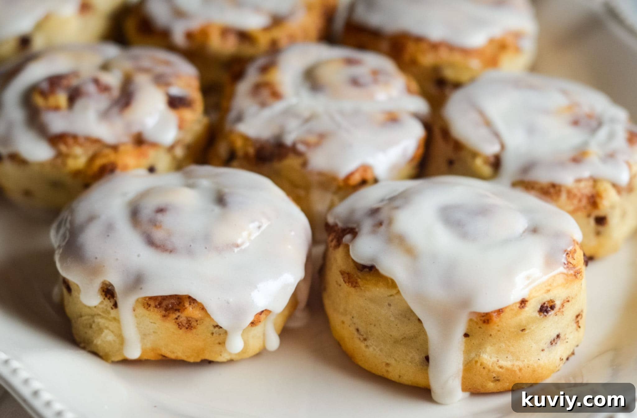 air fryer cinnamon rolls cooling with icing
