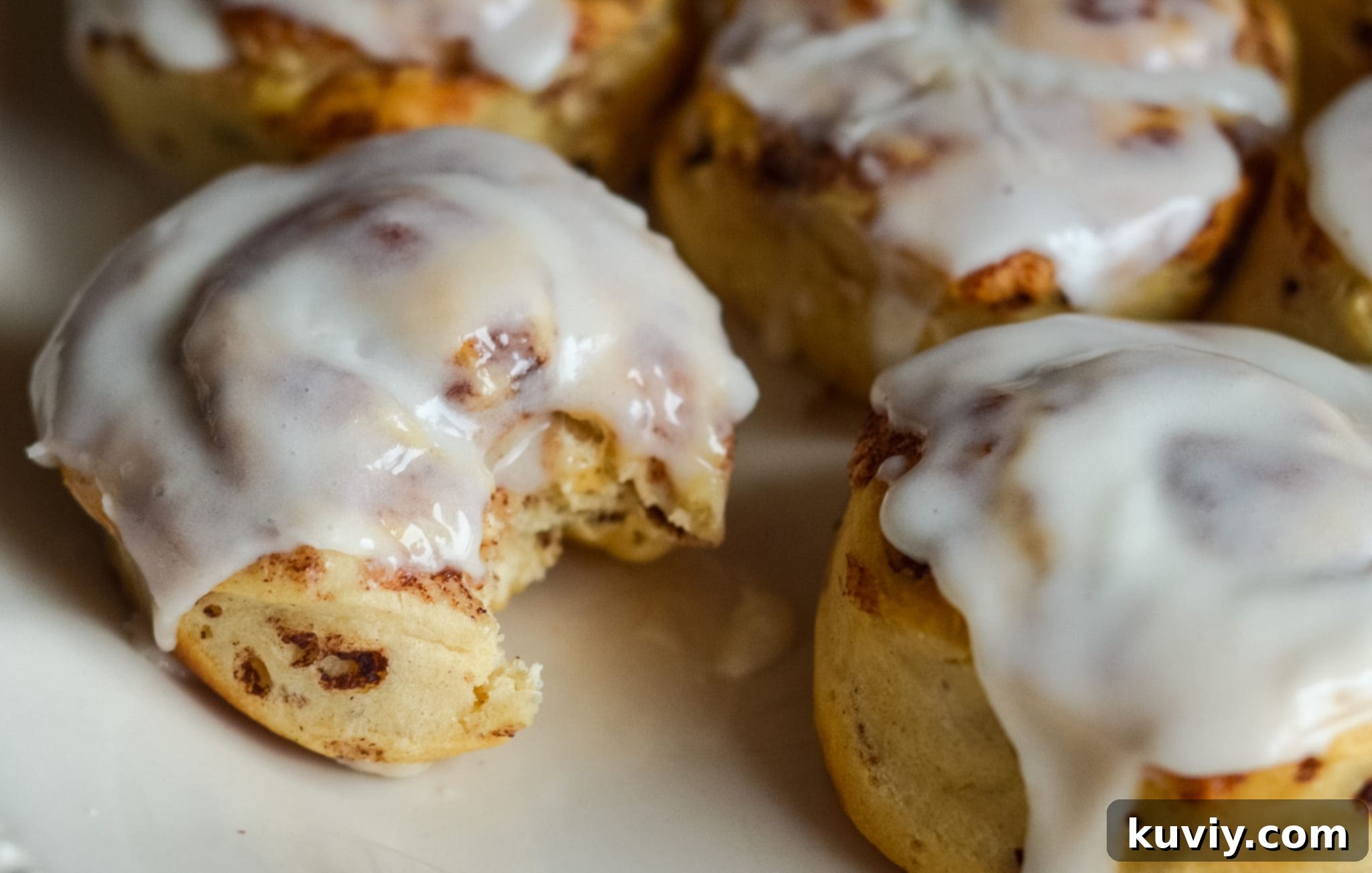 air fryer cinnamon rolls cooking in the air fryer basket