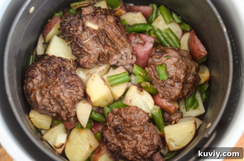 Cooked Hobo Dinner ingredients being transferred to a foil sheet for serving