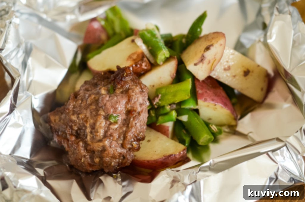 Ready-to-eat Air Fryer Hobo Dinner Foil Packet topped with melted cheese