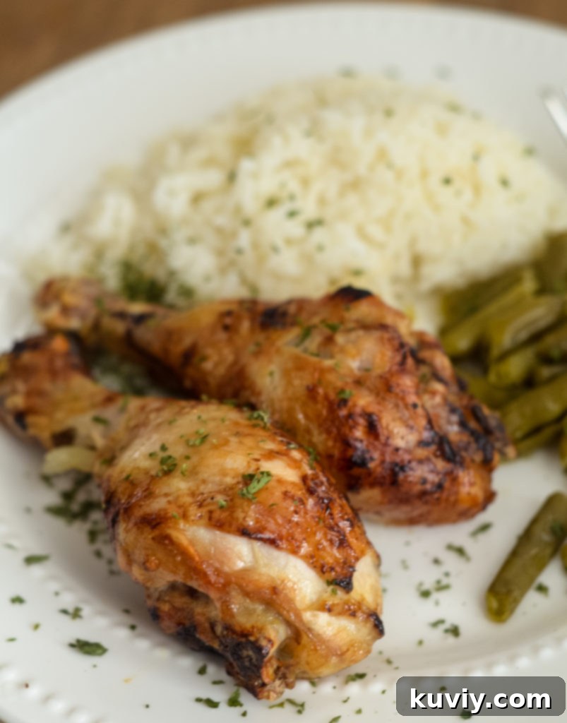 Air Fryer Teriyaki Chicken Legs plated with green beans and rice - gluten free.