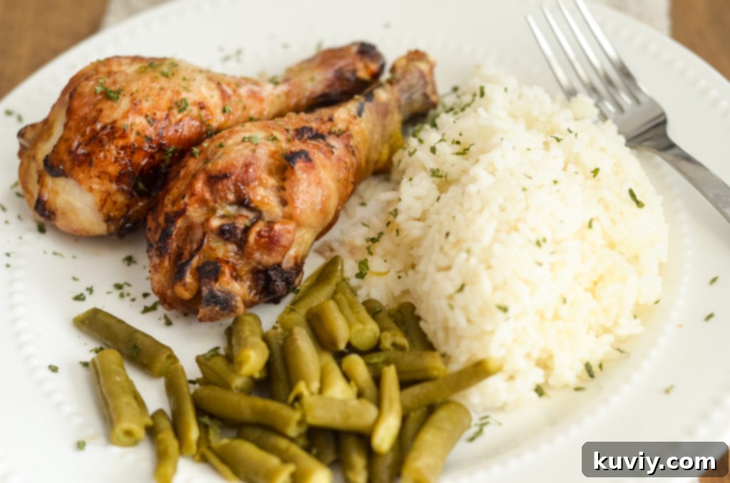 Air Fryer Teriyaki Chicken Legs plated with green beans and rice - gluten free.