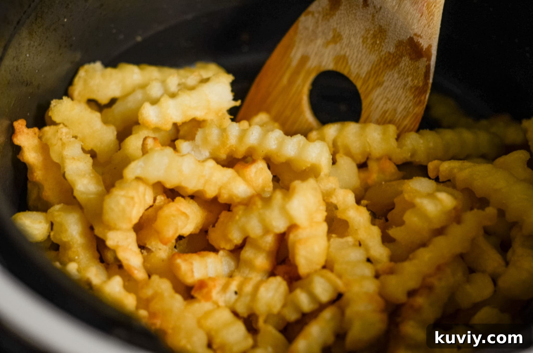 Easy Air Fryer Frozen French Fries: Crispy Perfection 4 Air fryer basket filled with evenly spread frozen french fries