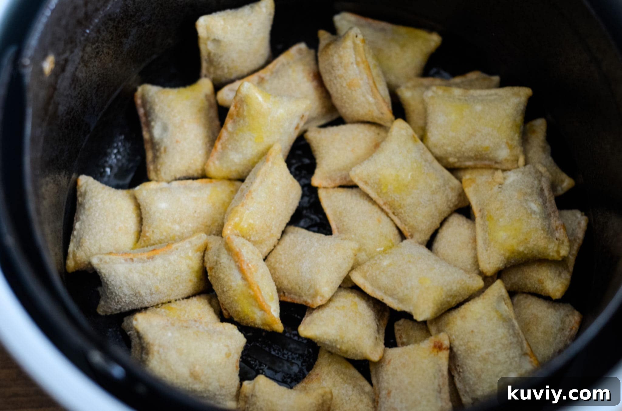 air fryer pizza rolls in air fryer basket ready to cook