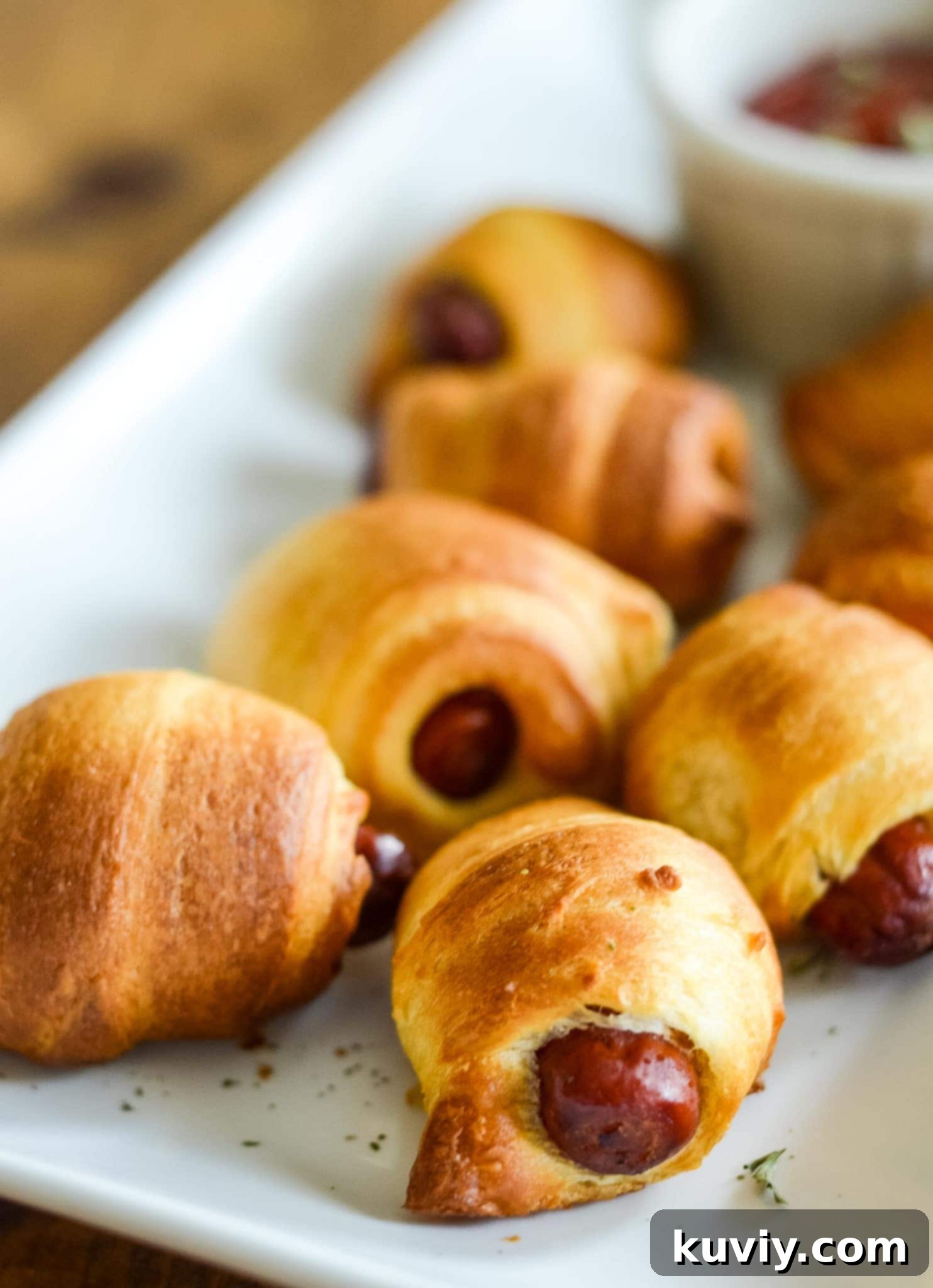 Crispy Air Fryer Pigs in a Blanket 2 Air Fryer Pigs in a Blanket, golden and crispy, served on a platter for an easy appetizer.