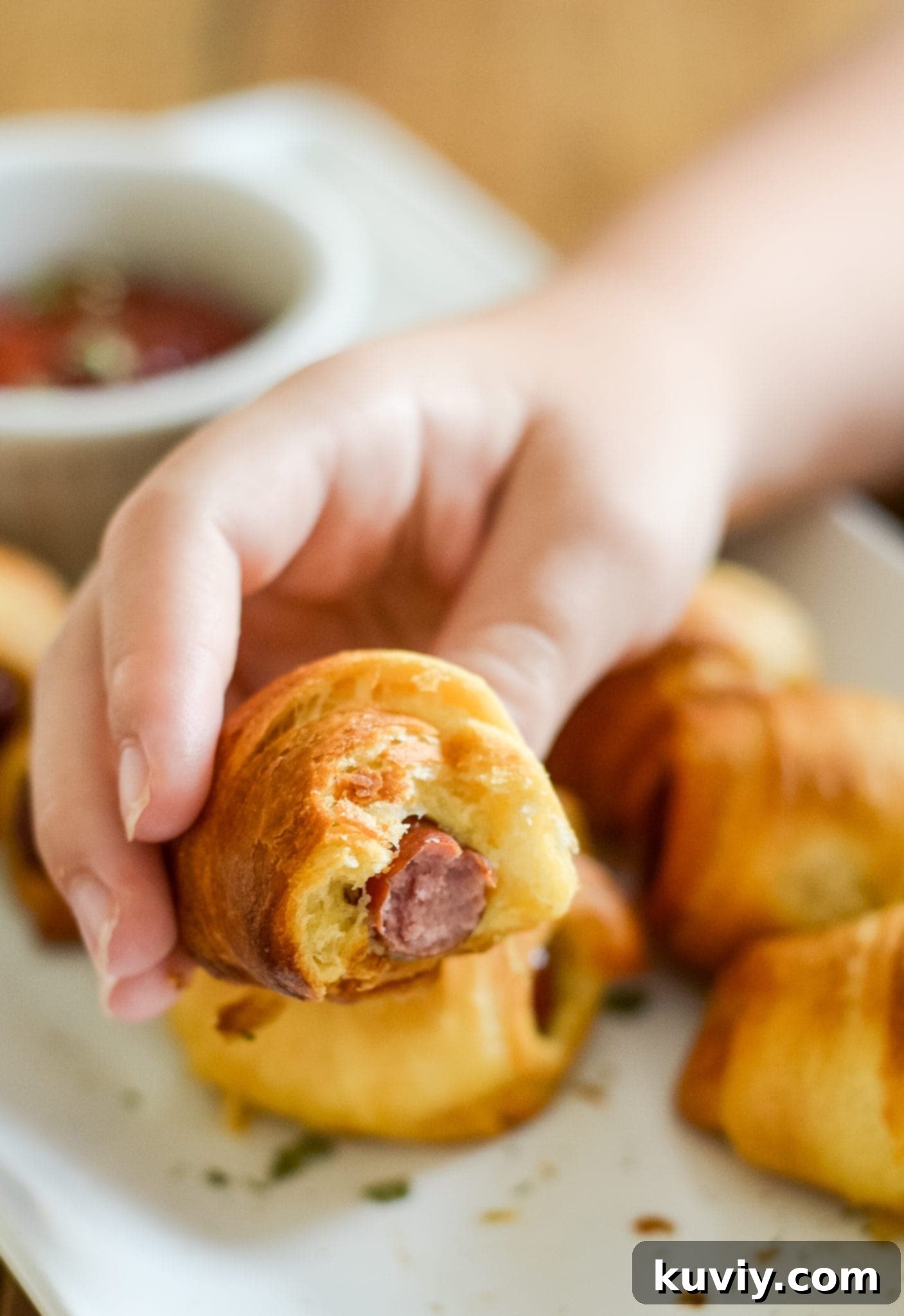 Crispy Air Fryer Pigs in a Blanket 5 Air Fryer Pigs in a Blanket stacked on a plate, ready to serve.