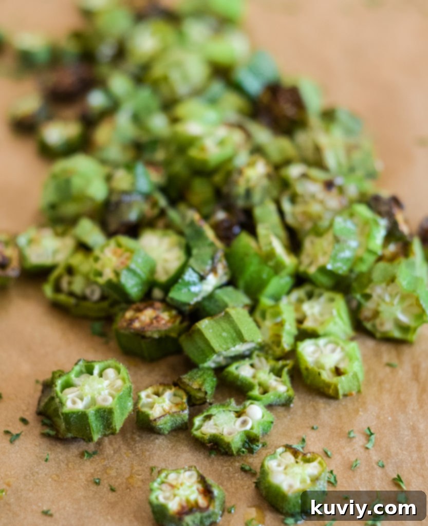 Fresh Air Fryer Roasted Okra in an air fryer basket, perfectly cooked.