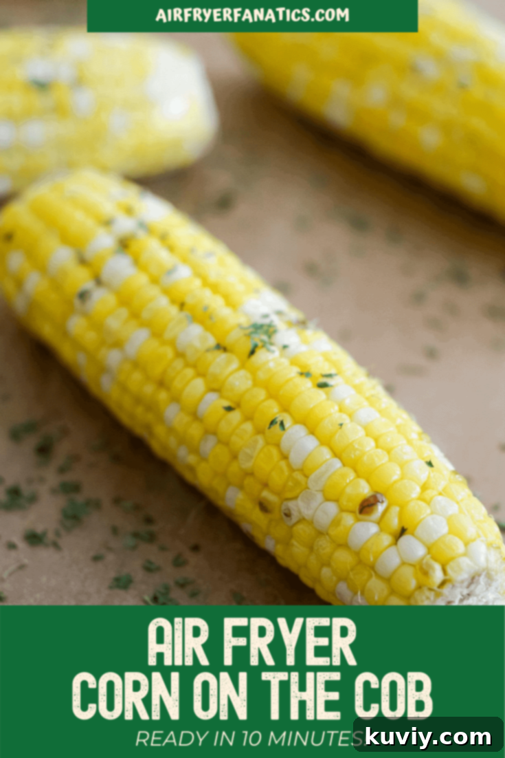 Beautifully roasted air fryer corn on the cob served on a cutting board, garnished with a sprig of fresh herb
