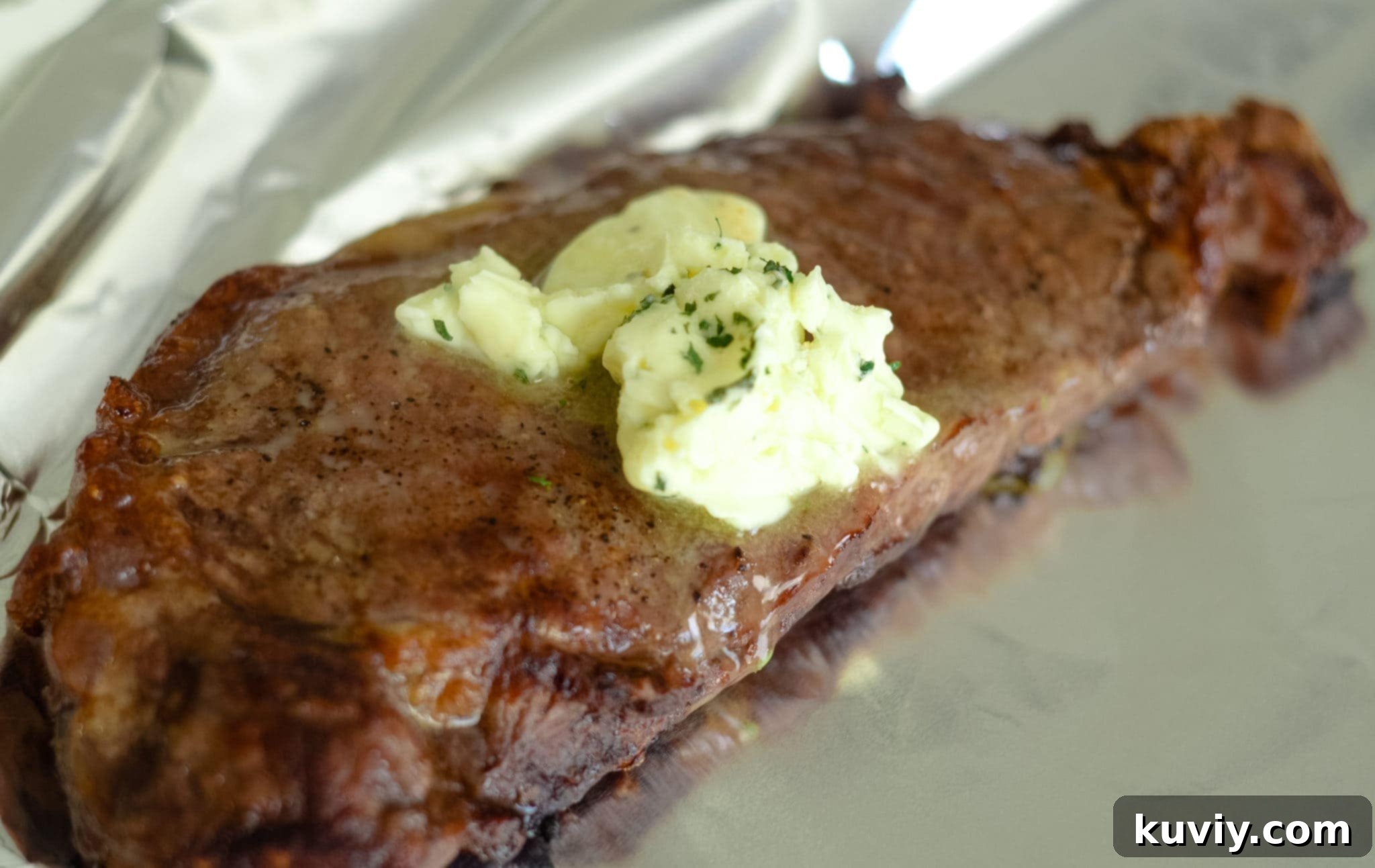 Perfectly cooked Air Fryer Garlic Butter Steaks in an air fryer basket