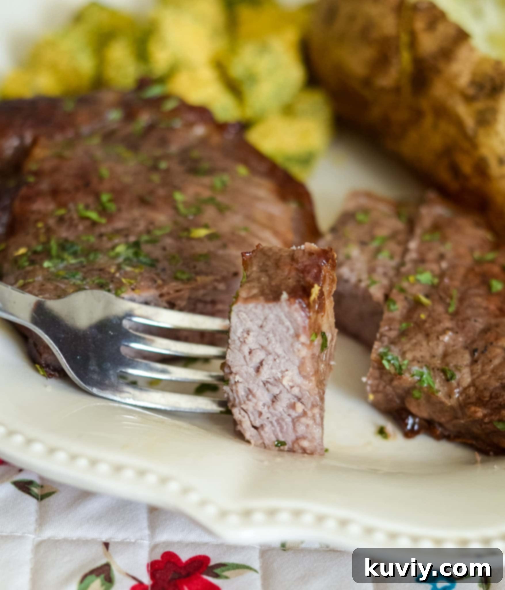 Two Air Fryer Garlic Butter Steaks on a cutting board, ready to be sliced