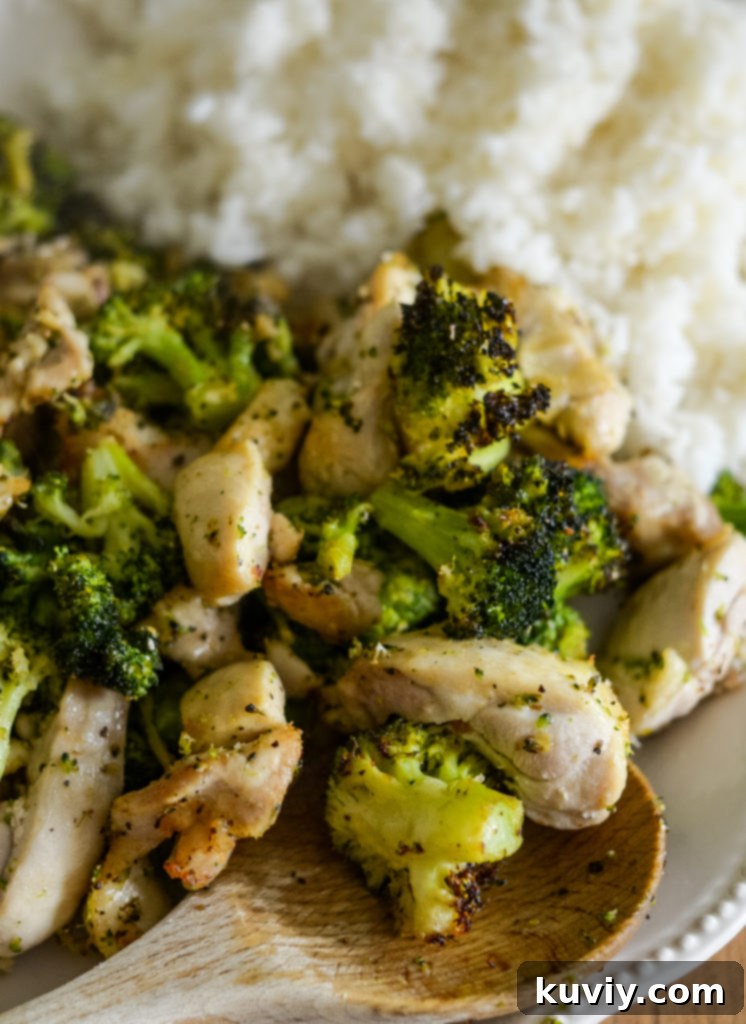 Prepared Air Fryer Chicken and Broccoli in a meal prep container with cauliflower rice.