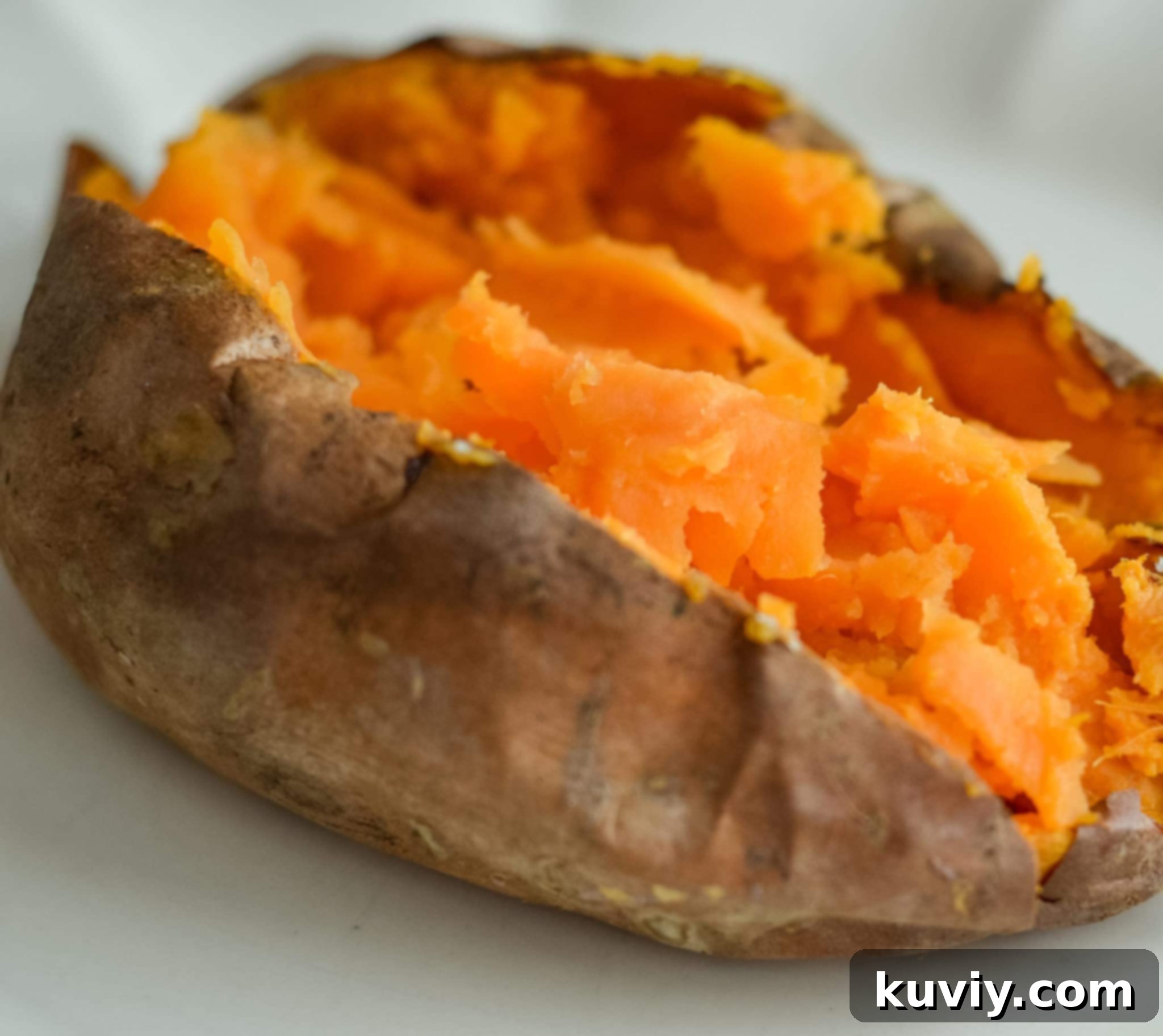 Air fryer basket filled with sweet potatoes ready for cooking