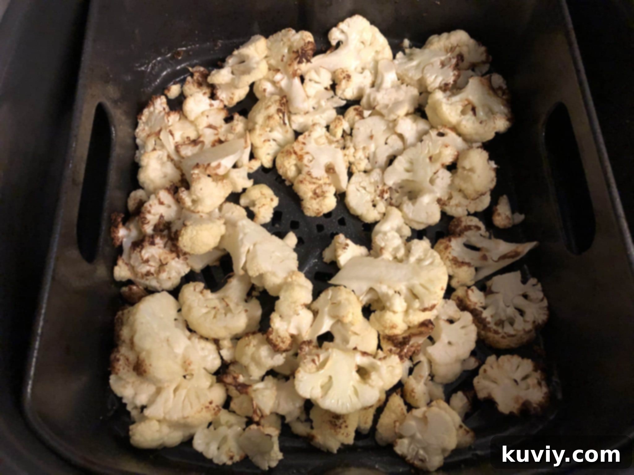 Air fryer with roasted cauliflower inside