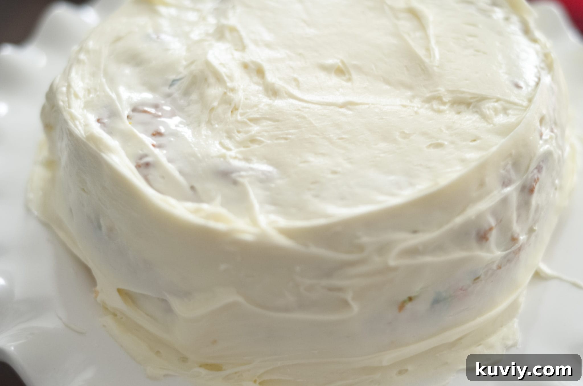 Removing Air Fryer Cake - Safely removing a baked cake from the air fryer basket with oven mitts.