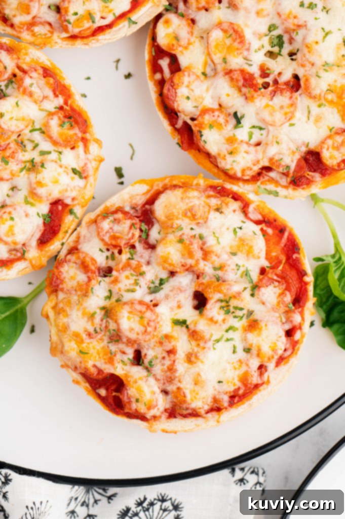 Crispy Air Fryer Pizza Bagels topped with pepperoni and cheese, fresh out of the air fryer