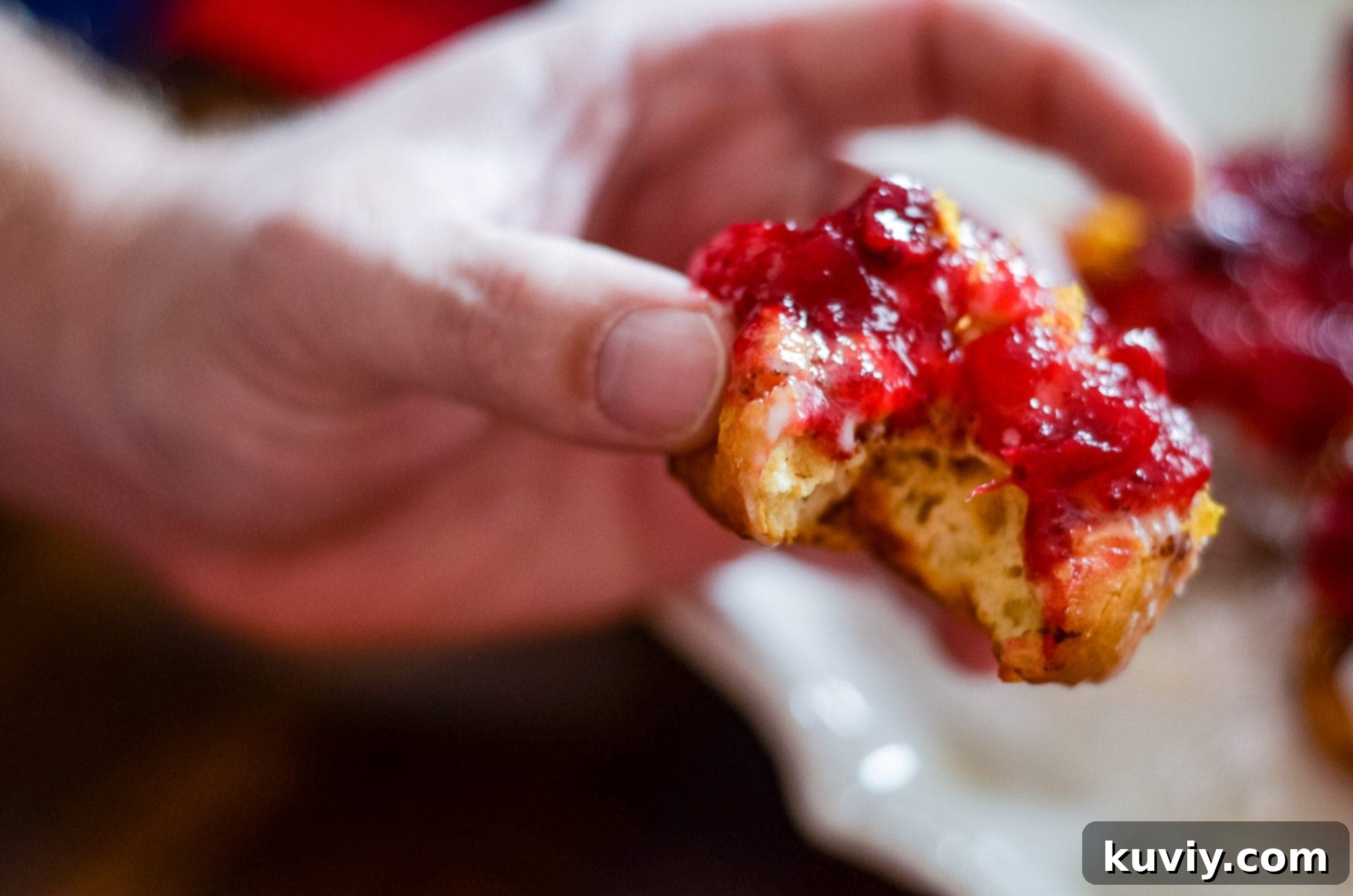 Air Fryer Cranberry Cinnamon Swirls with Zesty Glaze 5 Close-up of Air Fryer Cranberry Glazed Cinnamon Rolls, showing the glossy glaze.