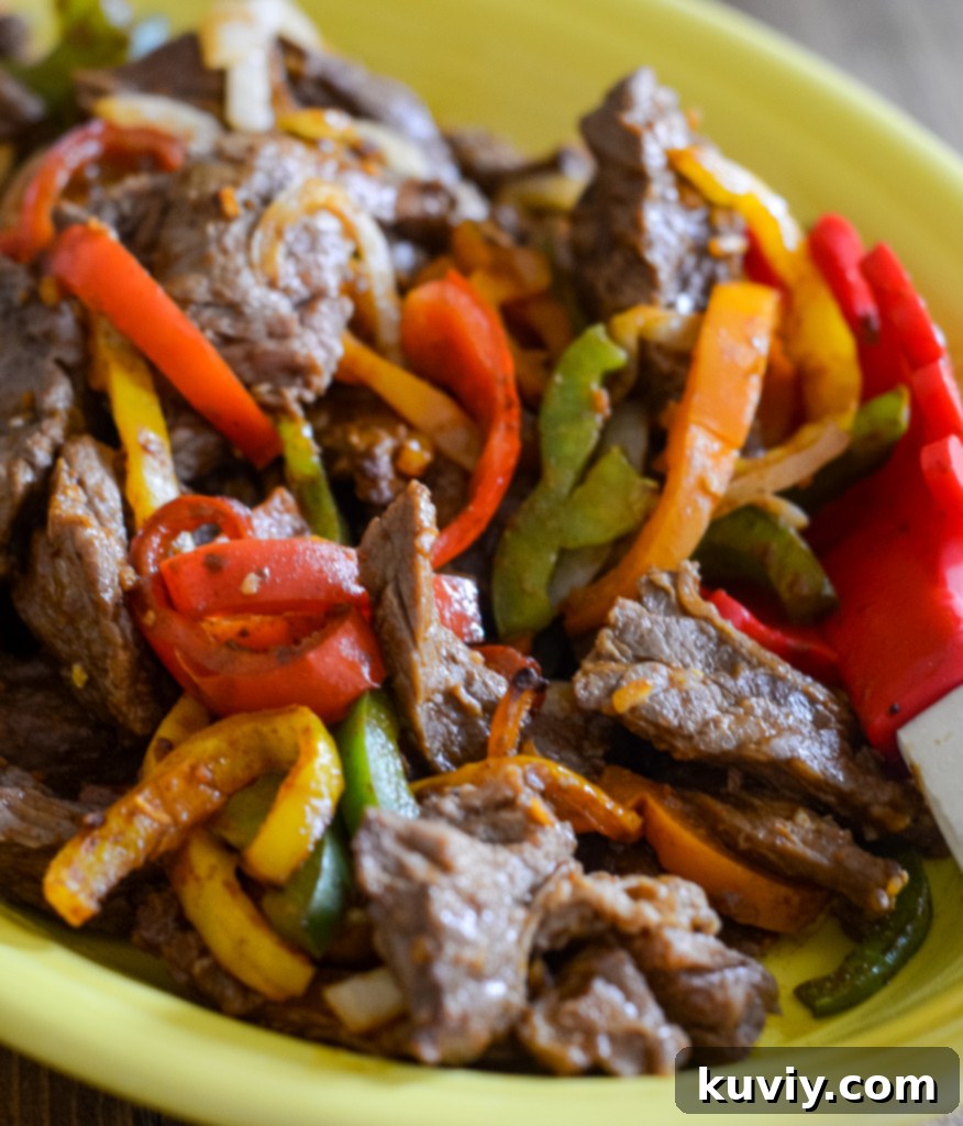 Delicious Air Fryer Steak Fajitas served with colorful peppers, onions, and tortillas.