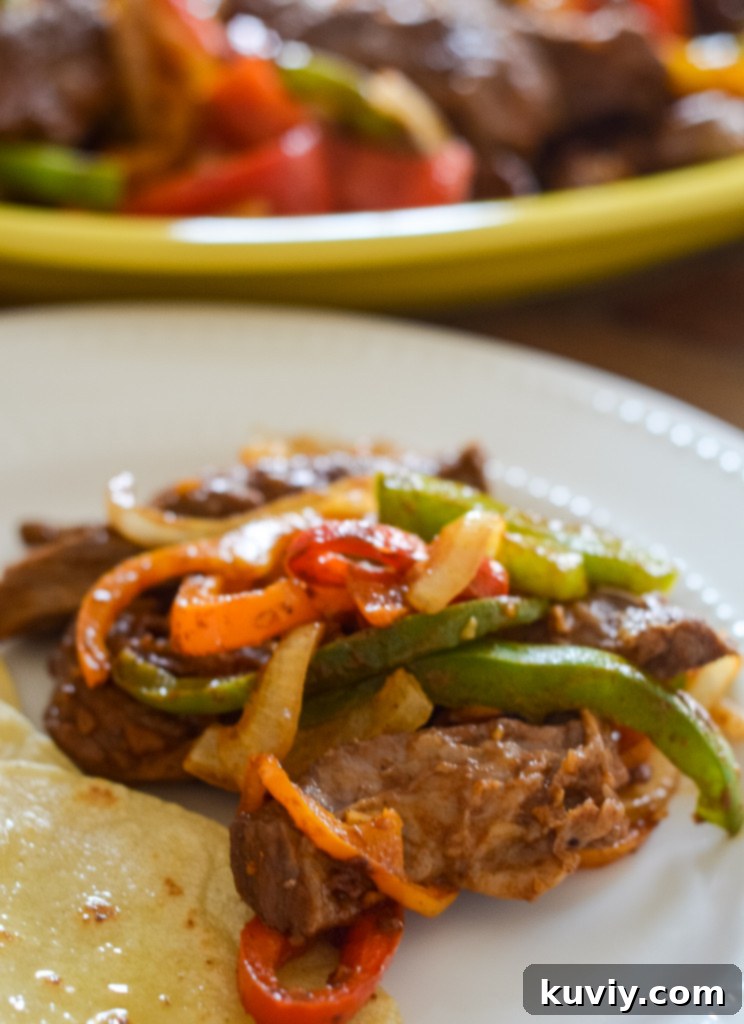 Platter of freshly cooked Air Fryer Steak Fajitas with vibrant vegetables, ready to be served.