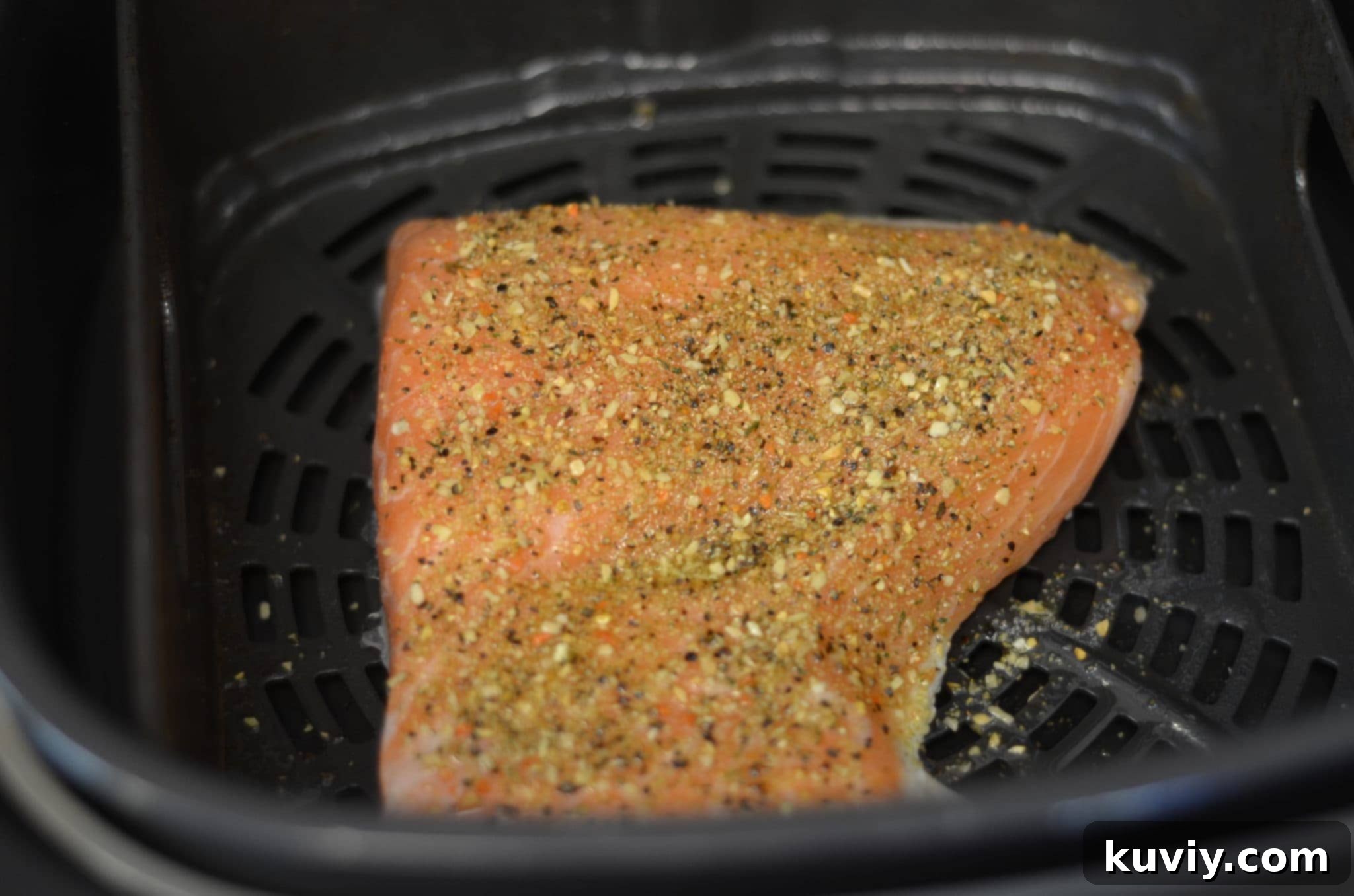 Fresh salmon fillet cooking in an air fryer basket