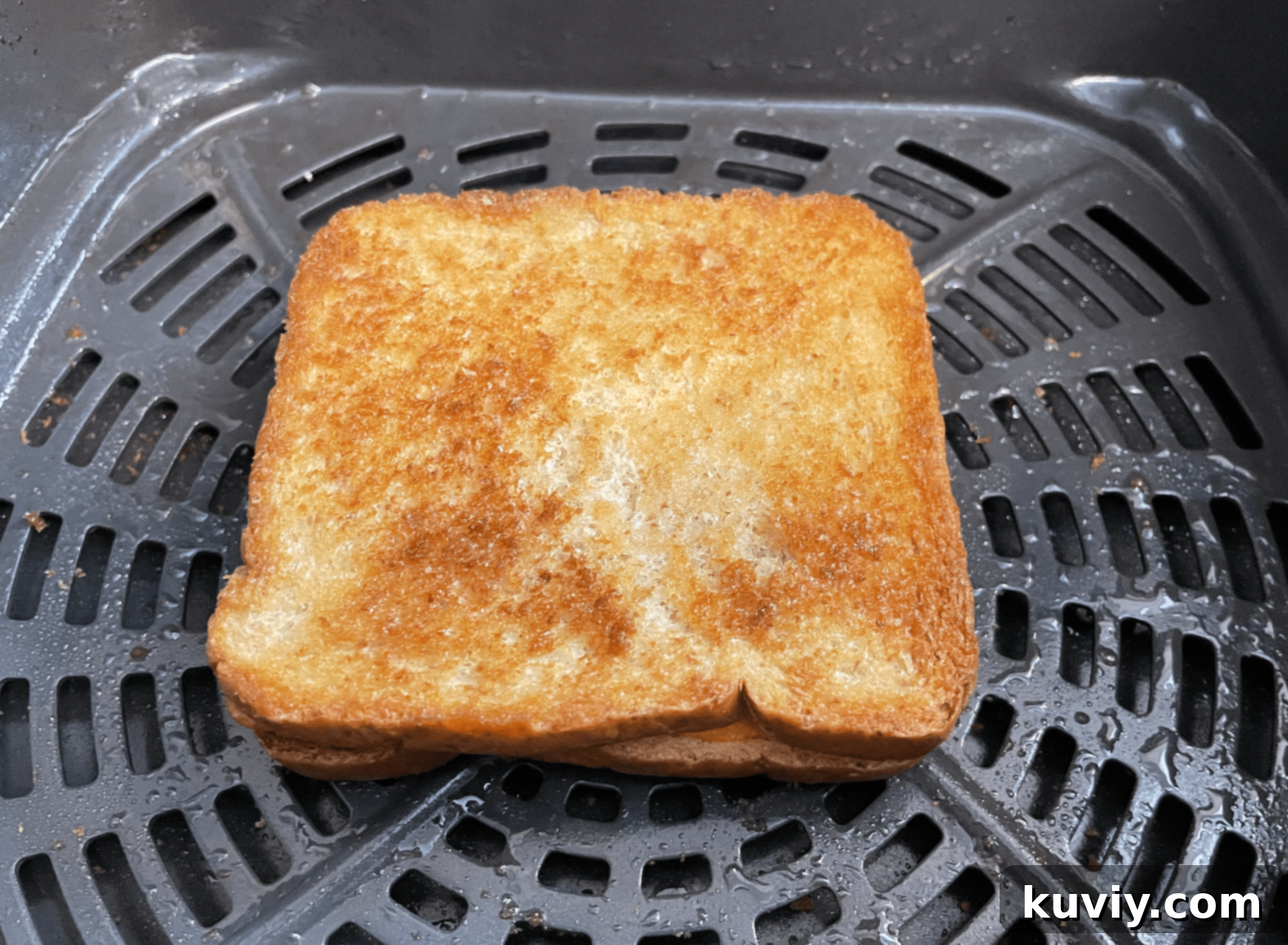 Uncooked Air Fryer Grilled Cheese sandwich showing buttered bread and cheese before cooking.