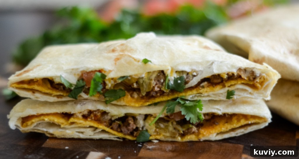 Close-up of a perfectly golden Air Fryer Crunchwrap, sliced to show the layers
