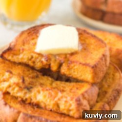 Air Fryer Pumpkin French Toast, garnished with syrup and powdered sugar