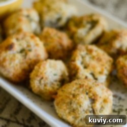 A plate of perfectly golden and crispy air-fried mushrooms, garnished with fresh parsley.