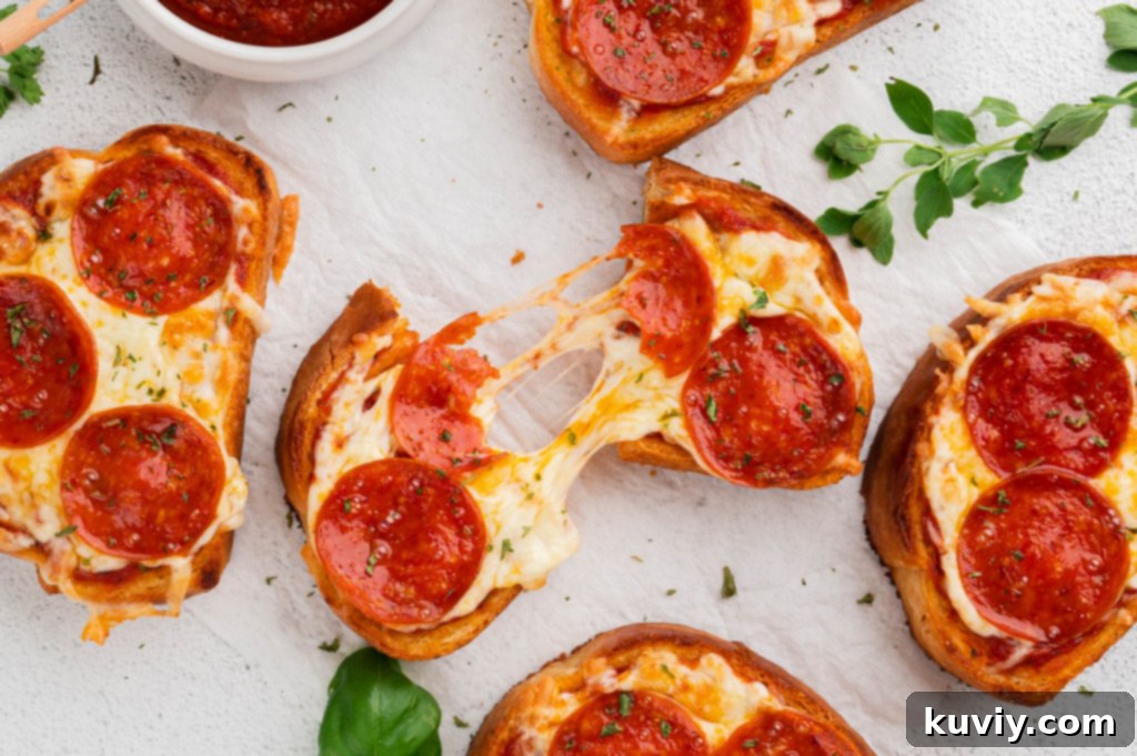 Three slices of Air Fryer Garlic Bread Pizza Toast on a cutting board, garnished with fresh basil